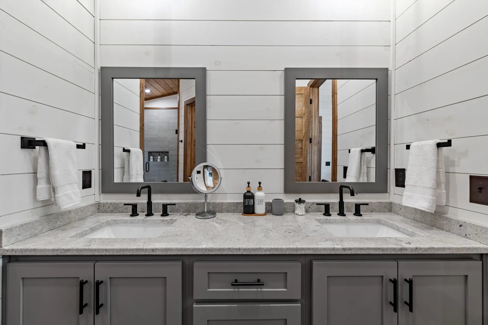 Vanity with dual sinks and ample bathroom storage.