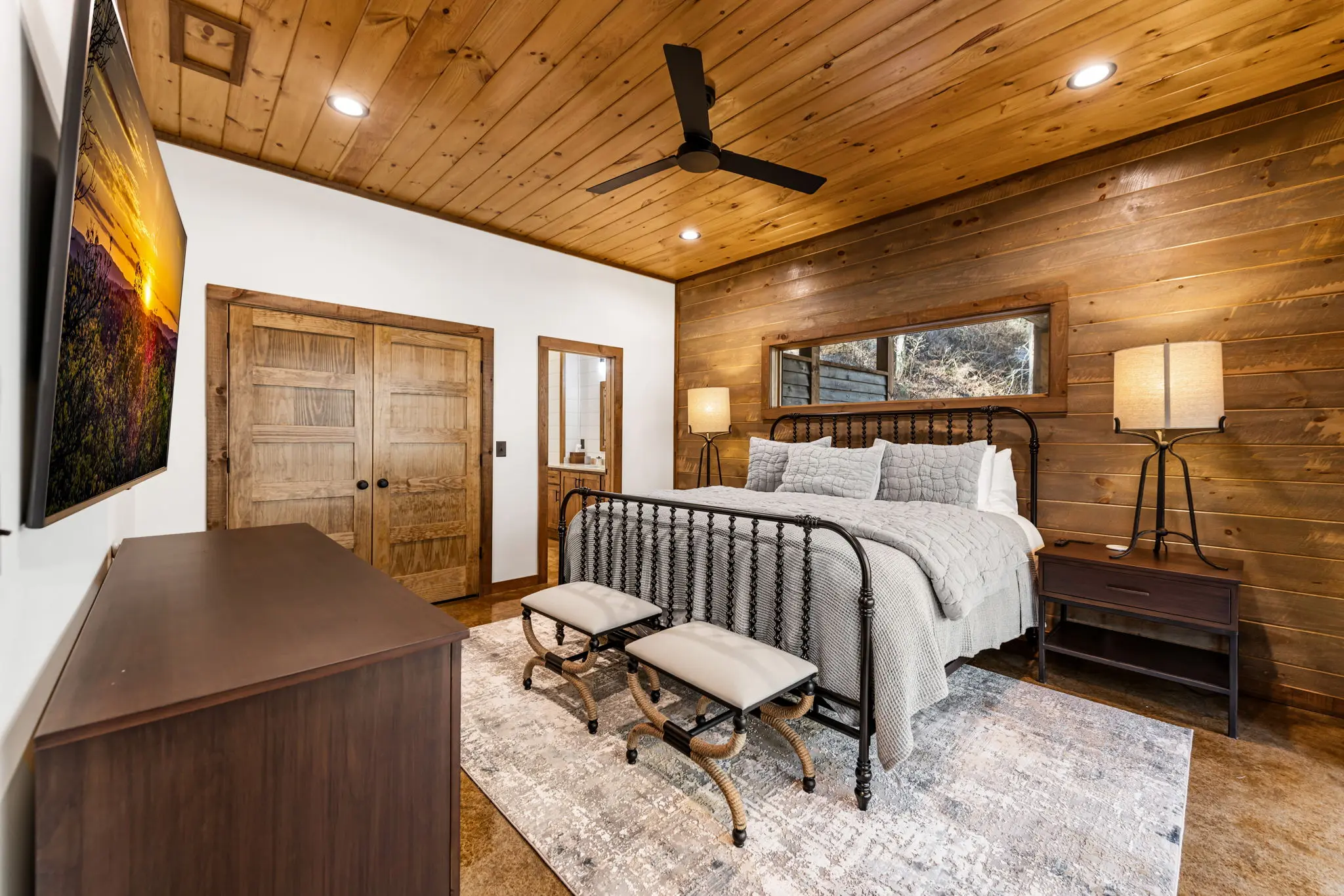 Lower level primary bedroom with comfortable furnishings.